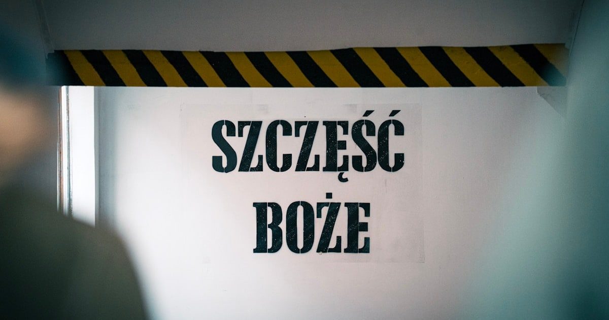 Blessings at the entrance! The phrase 'Szczęść Boże' warmly greets visitors on the wall before entering the mine, symbolizing hope and tradition tied to the miner's heritage and faith.