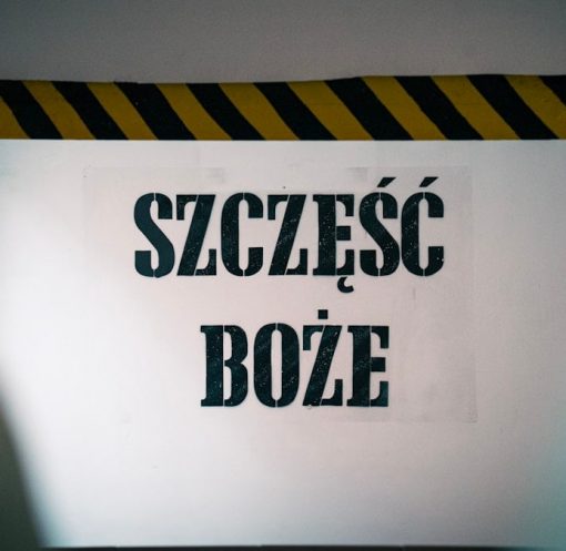 Blessings at the entrance! The phrase 'Szczęść Boże' warmly greets visitors on the wall before entering the mine, symbolizing hope and tradition tied to the miner's heritage and faith.