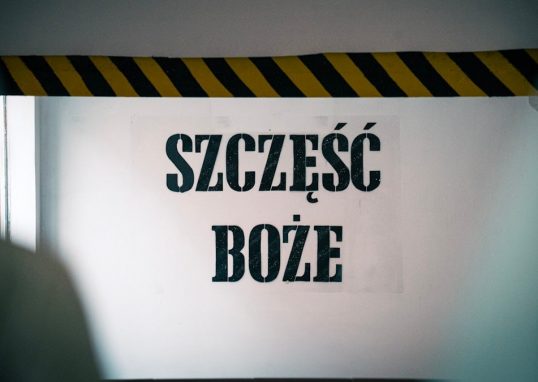 Blessings at the entrance! The phrase 'Szczęść Boże' warmly greets visitors on the wall before entering the mine, symbolizing hope and tradition tied to the miner's heritage and faith.