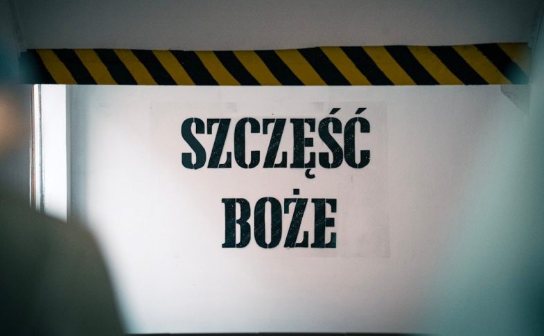Blessings at the entrance! The phrase 'Szczęść Boże' warmly greets visitors on the wall before entering the mine, symbolizing hope and tradition tied to the miner's heritage and faith.